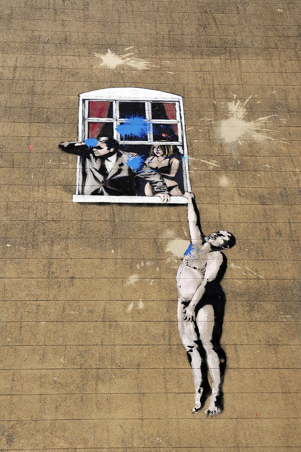 Banksy mural of naked man hanging out of window