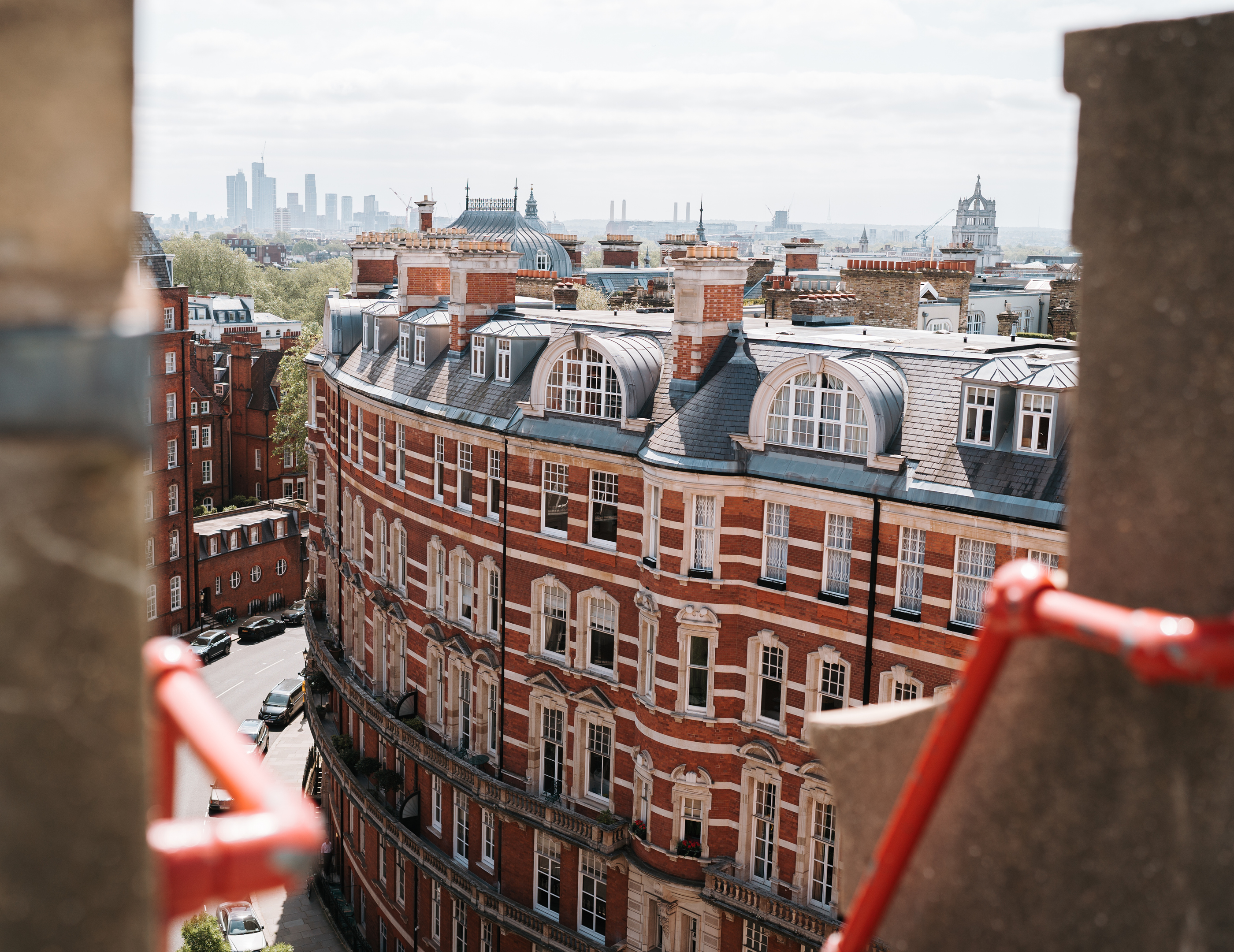 View from rooftop over red brick old building and London skyline in distance