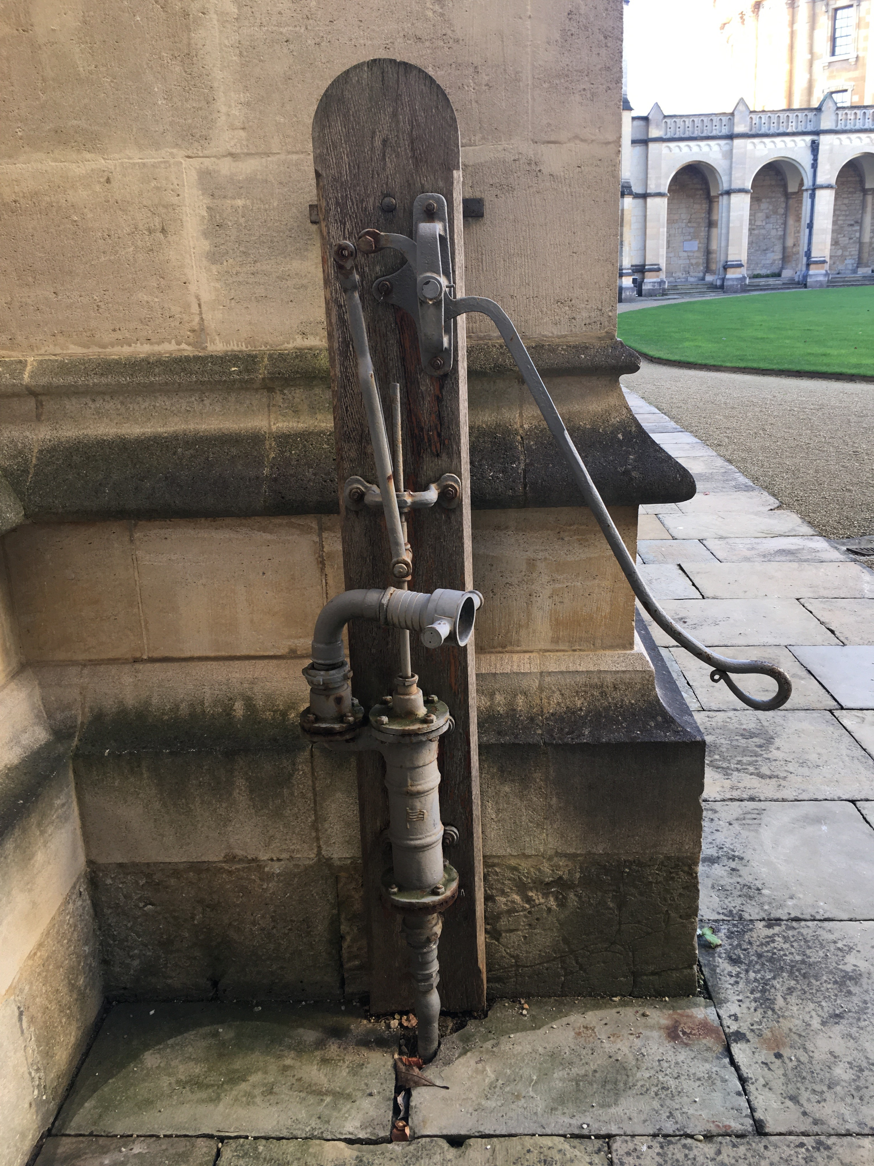 Unsuitable water supply: modern coupling fitted to old lead pipe with hand pump