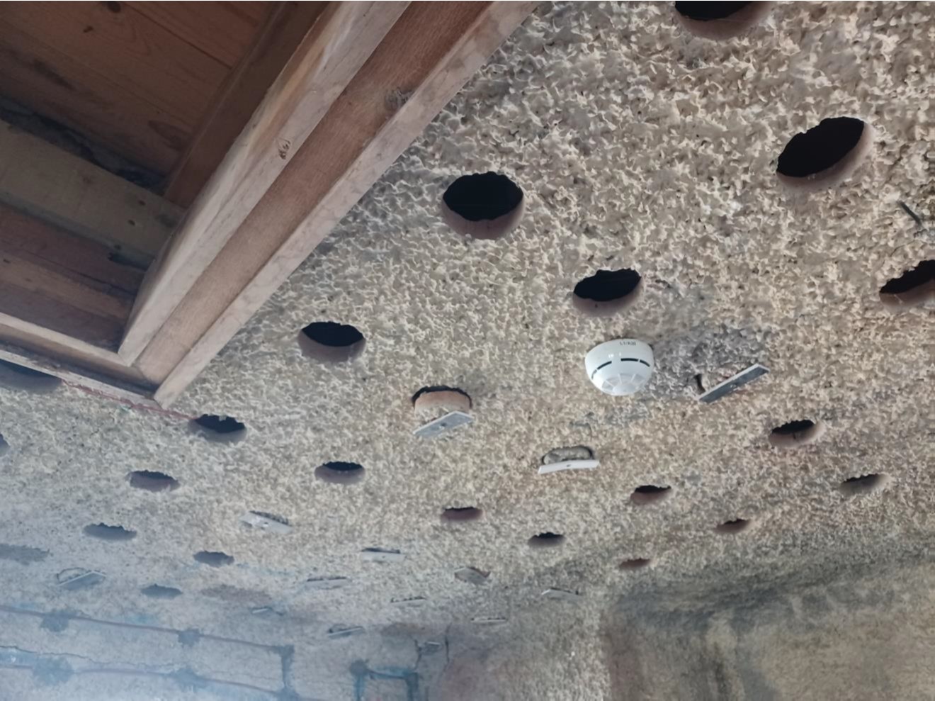 Holes cored through the render and terracotta pots for anode installation