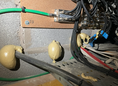 Expanding foam used to seal service penetrations in a compartment wall.