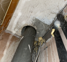  Oversized core hole in a compartment floor with a SVP passing through with no firestopping present.