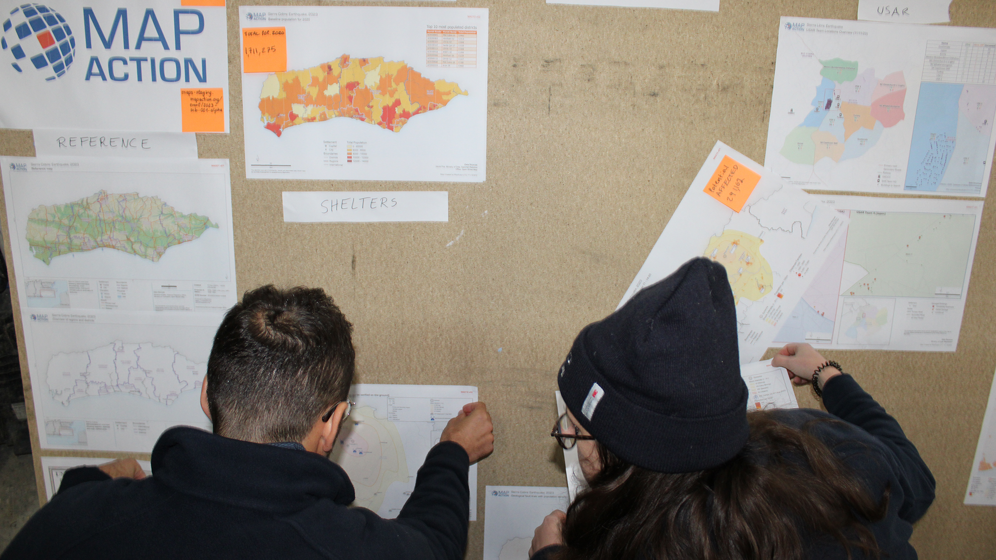 Two volunteers looking at maps