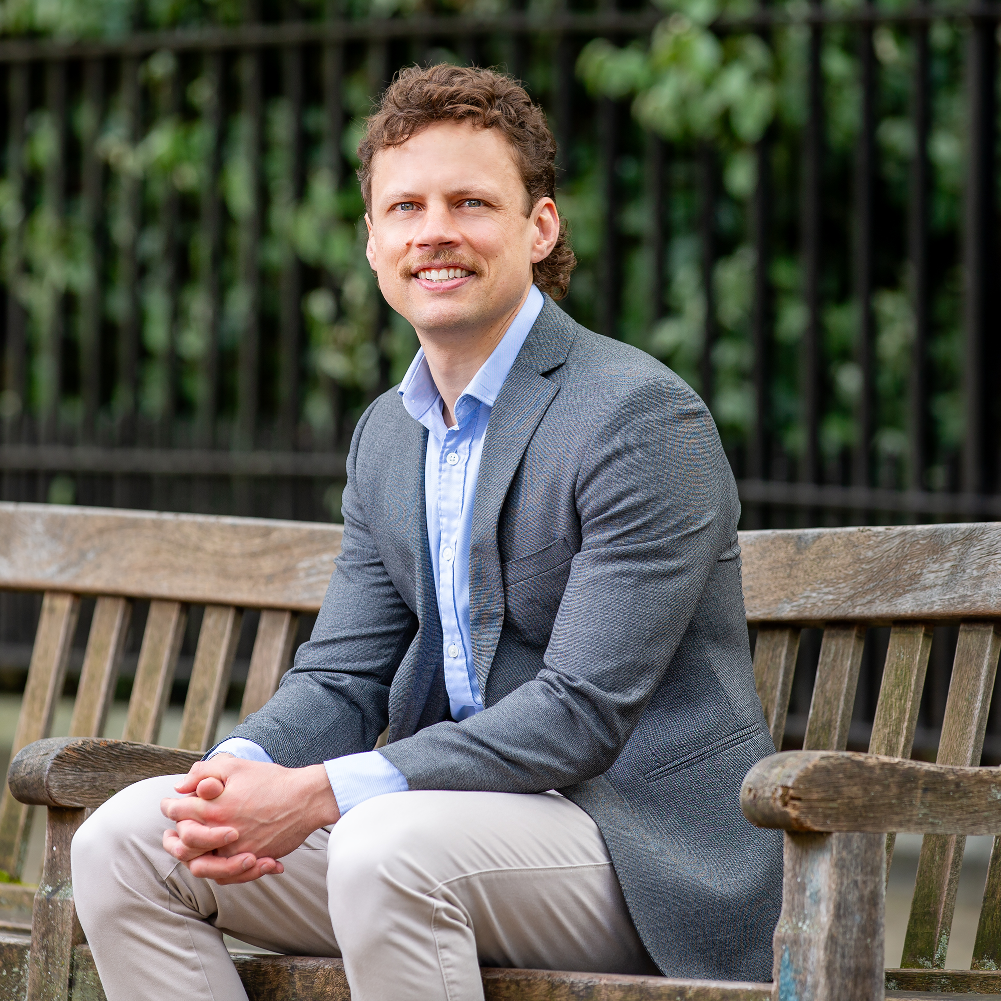 Ian Cameron seated on bench outside