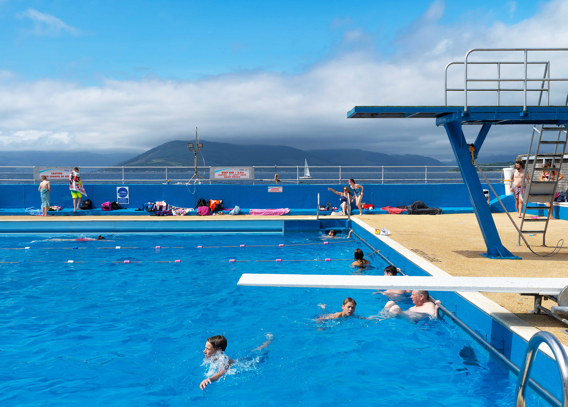 Gourock Outdoor Pool Kids in outdoor pool with mountains in the distance