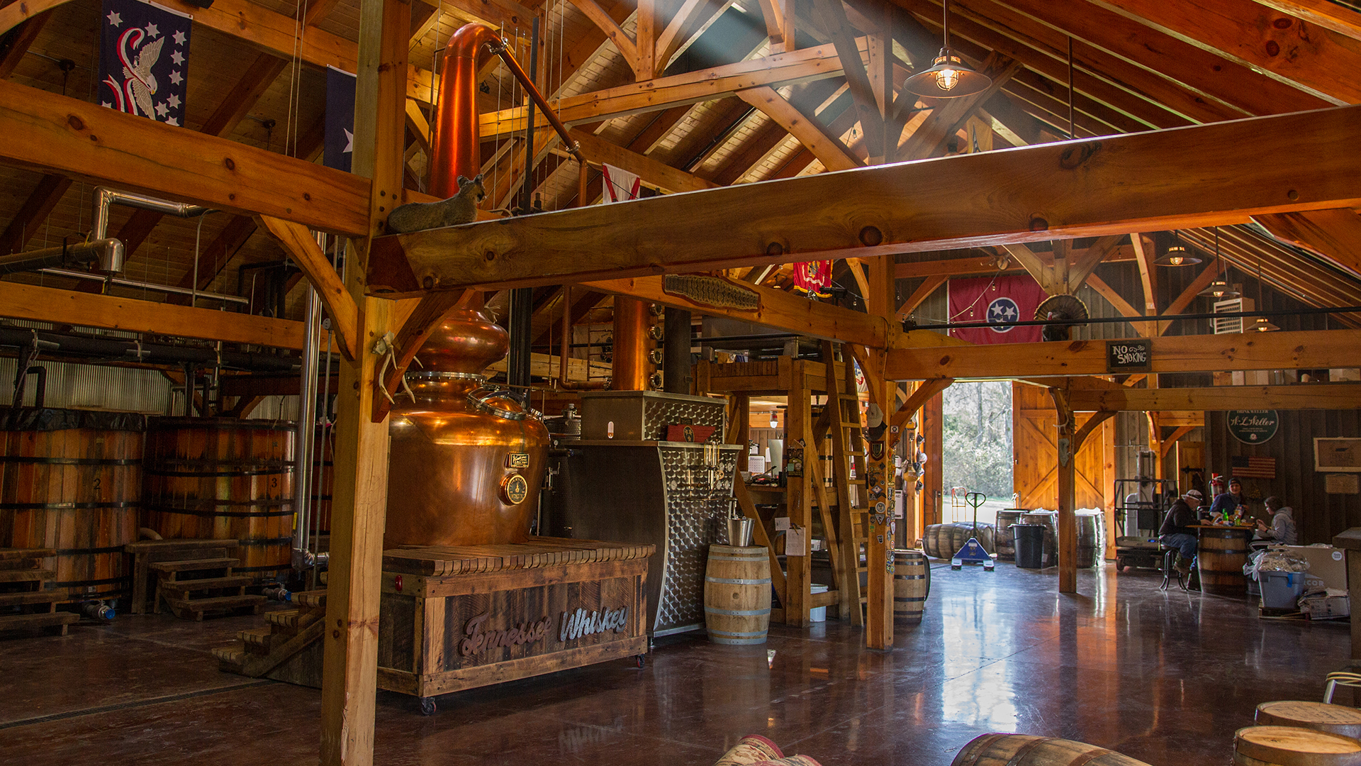 Inside a barn structure with whisky distillery equipment
