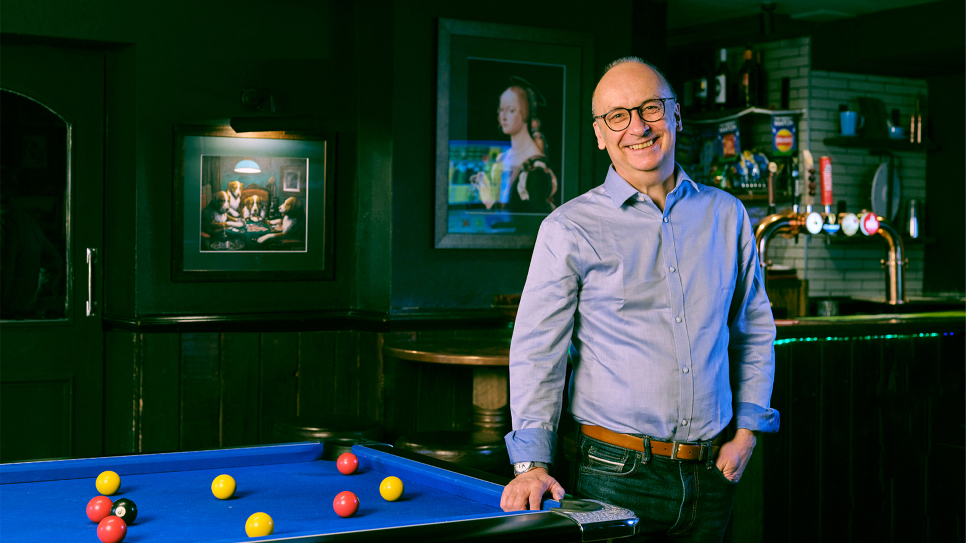 Stephen stood next to a pool table in pub
