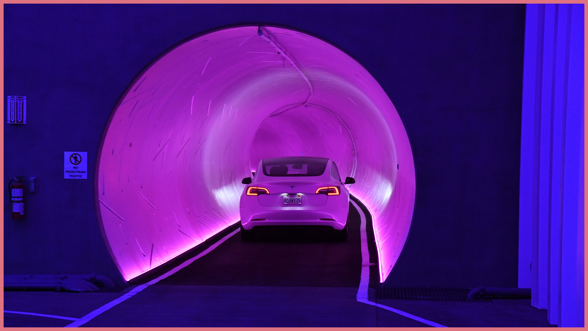 Tesla driving through purple tinted tunnel