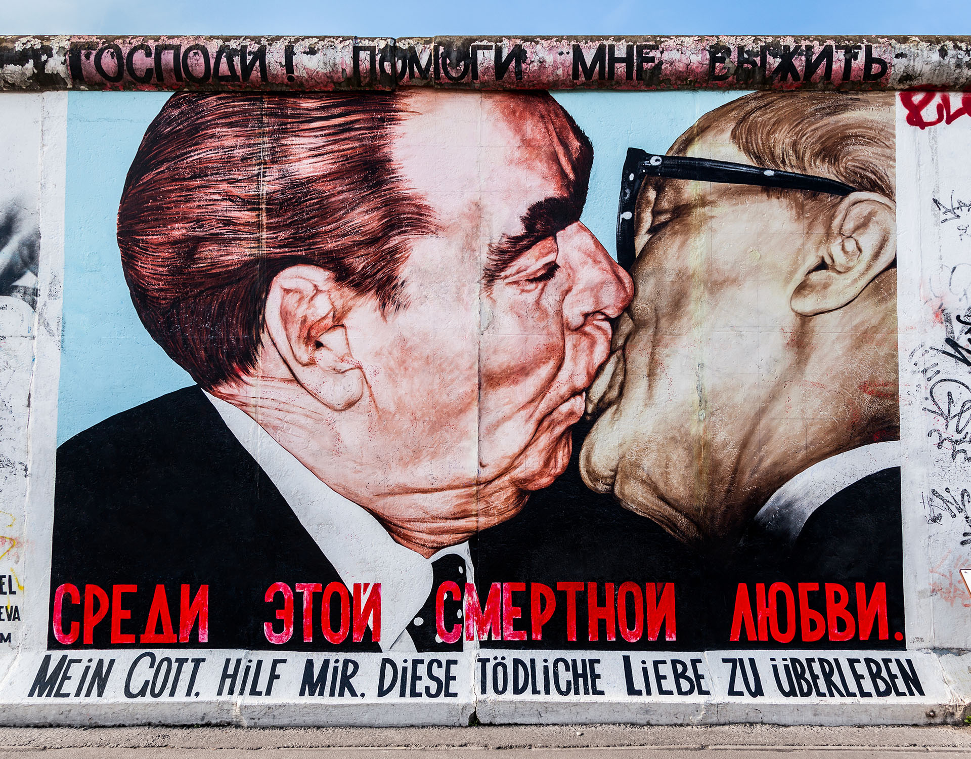 Mural of two male politicians kissing on Berlin wall