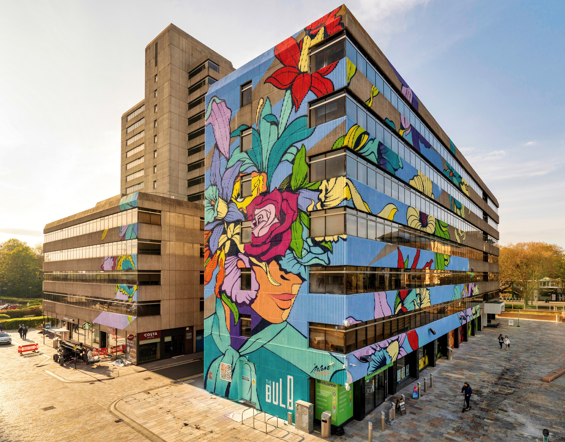 Colourful mural on the side of old concrete office building