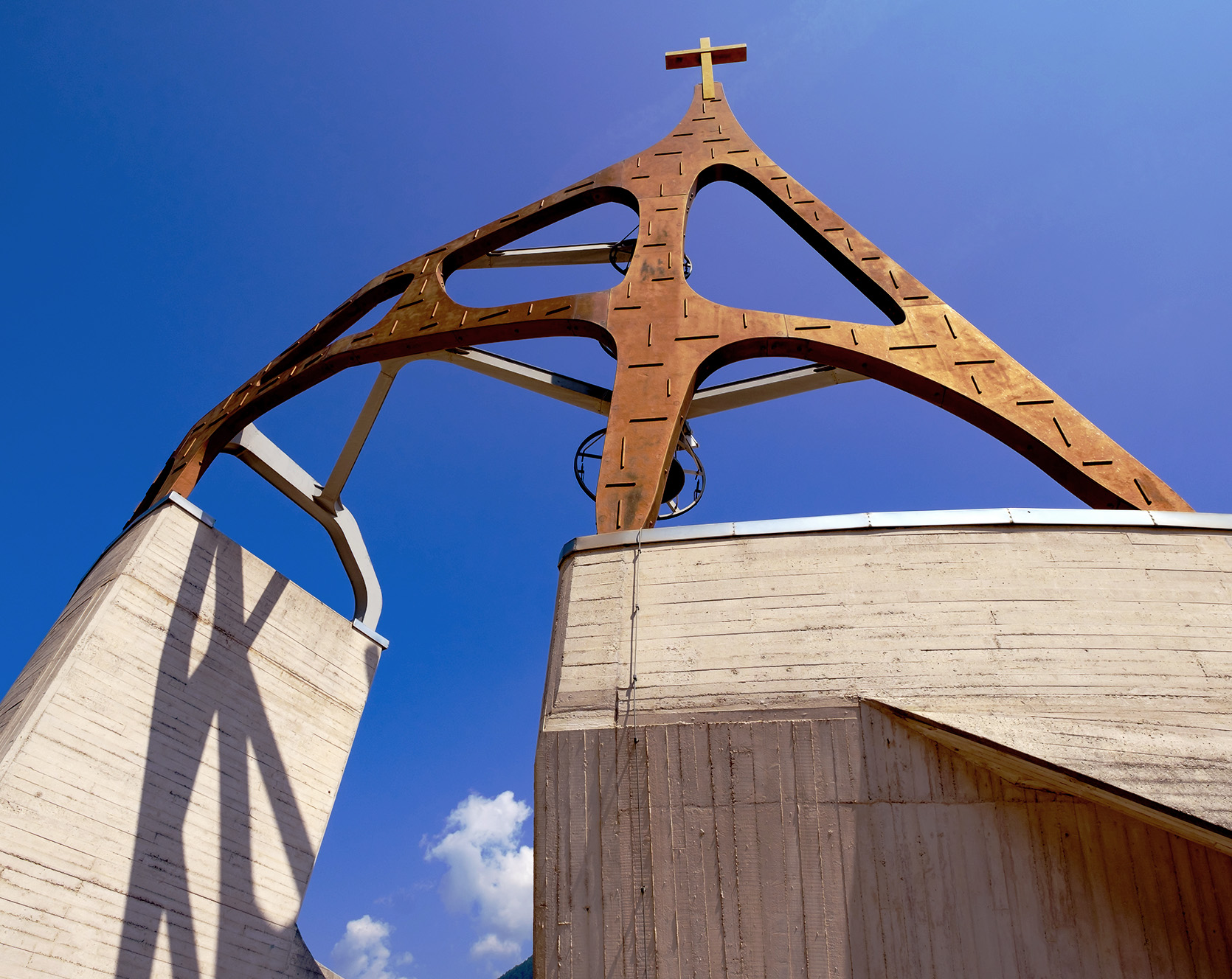 Chiesa della Beata Vergine Santa Maria Immacolata, Longarone Close up of metal cross structure atop concrete church walls
