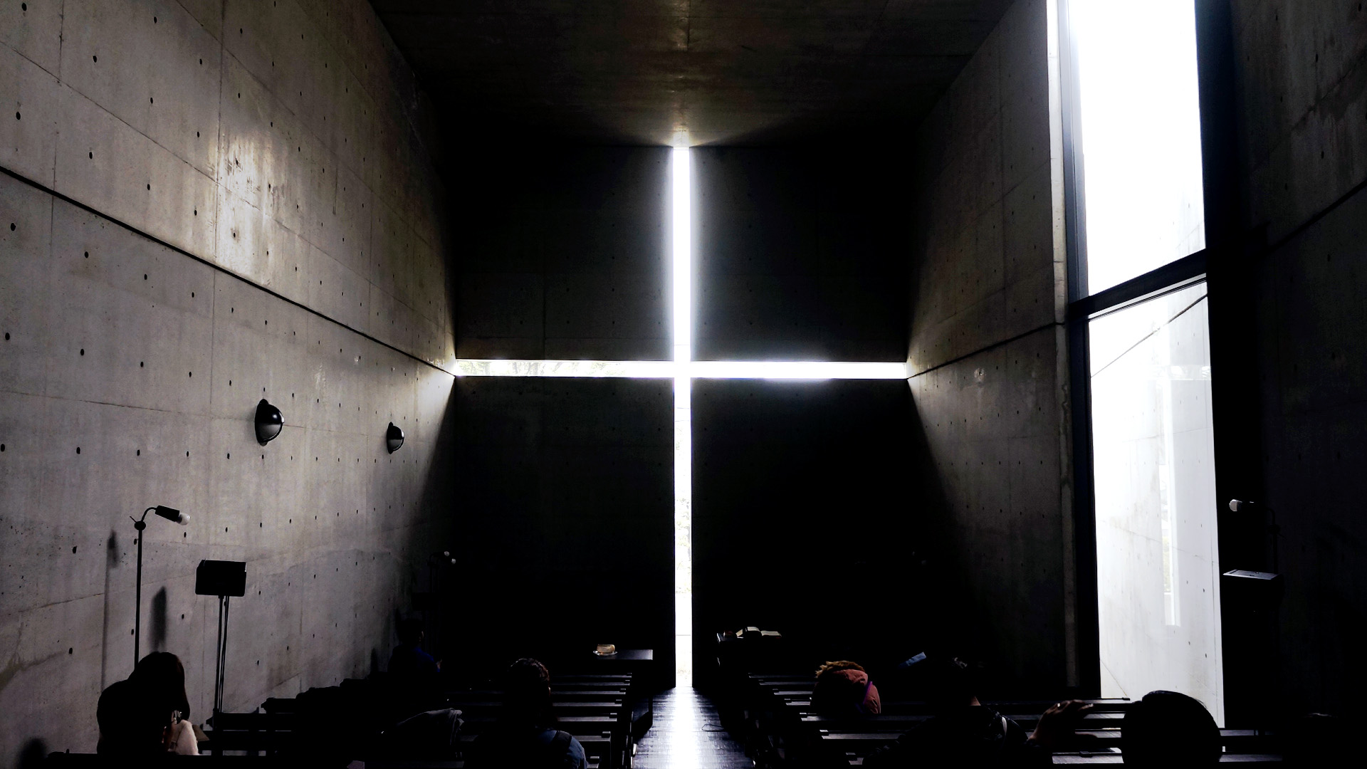 Church of the light, Osaka Concrete interior of church. At the end of the aisle is a cross carved out of a concrete wall with the light shining through