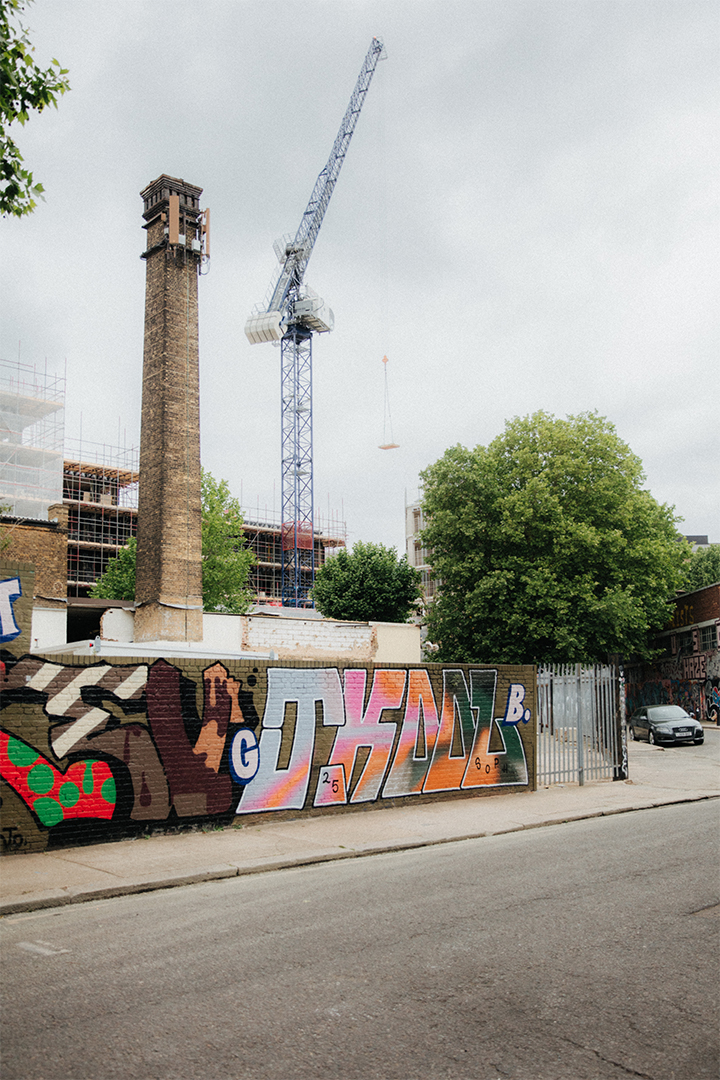 Hackney Wick skyline Old mill next to crane and graffitied wall in Hackney Wick
