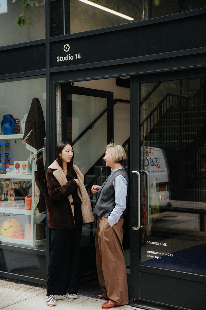 Yulia Pak MRICS creative business Yulia speaks to shop owner outside shop front