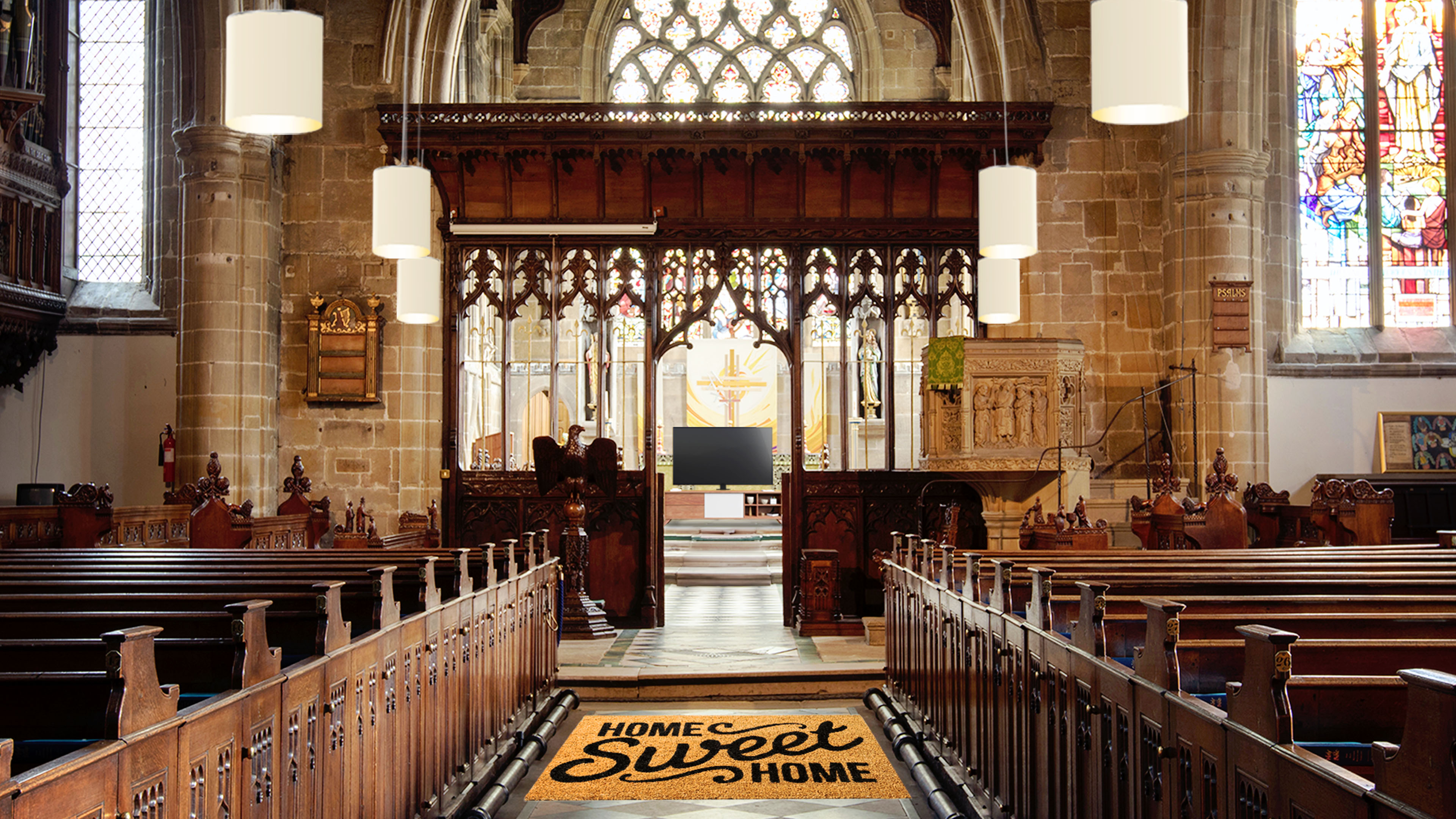 Looking down aisle of Church with mat saying home sweet home