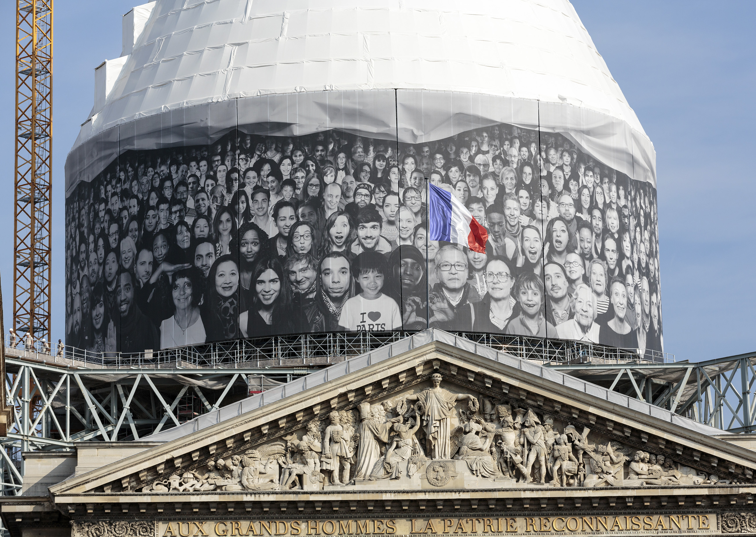 Dome of the Pantheon building covered in wrap with people's faces on