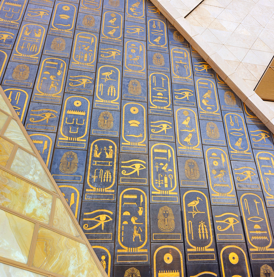 Grand Egyptian Museum hieroglyphs Hieroglyphs across pyramid shaped wall opening into museum entrance