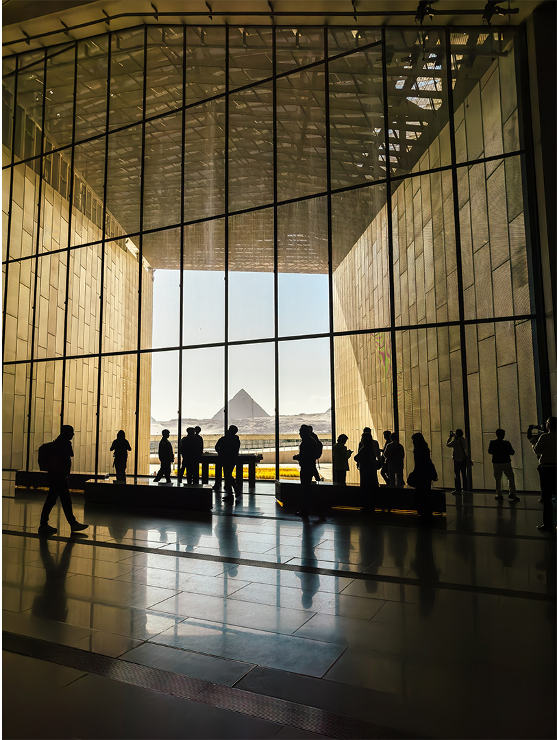 Grand Egyptian Museum view of the Pyramids of Giza Looking out of big windows inside museum to the Pyramids of Giza