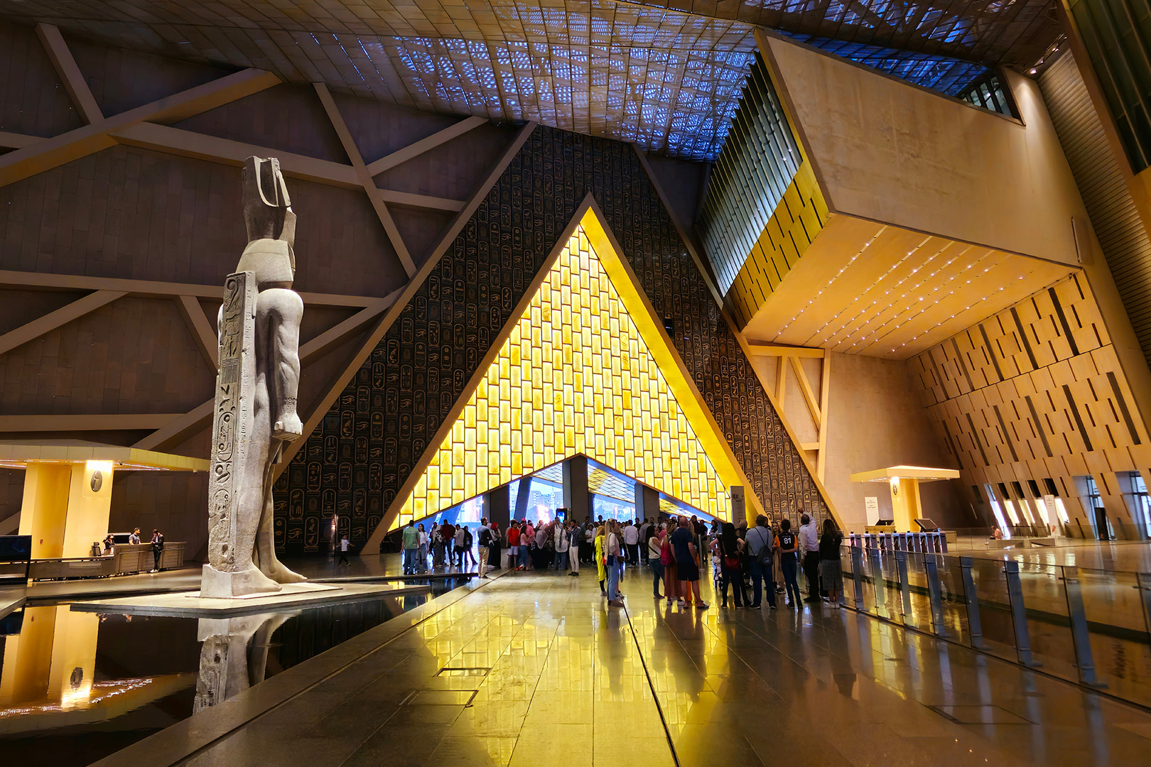 Grand Egyptian Museum entrance lit up Crowds of visitors leaving museum entrance lit up at night