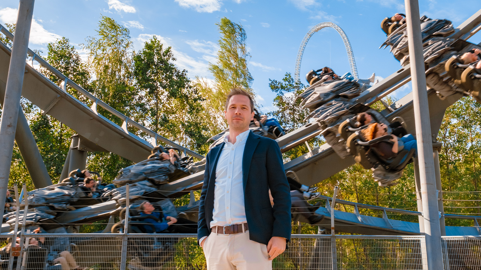 Christopher Bird MRICS in front of trees and a rollercoaster 