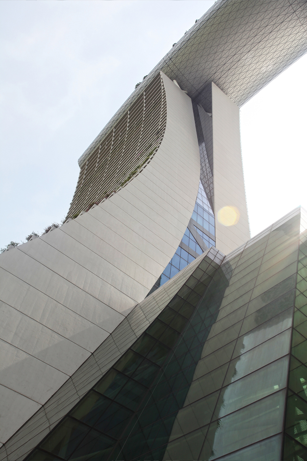 Photo looking up at Marina Bay Sands with light coming through