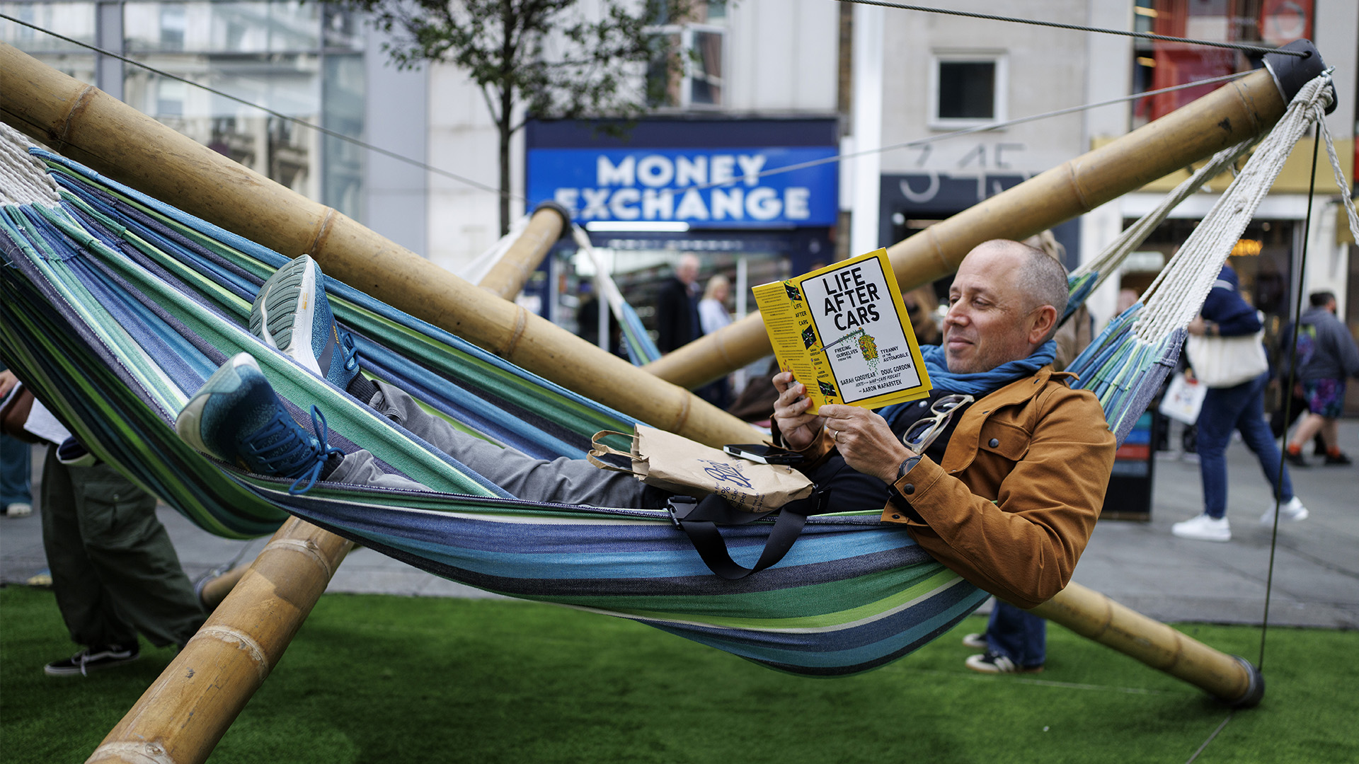 Man in a hammock on Oxford Street
