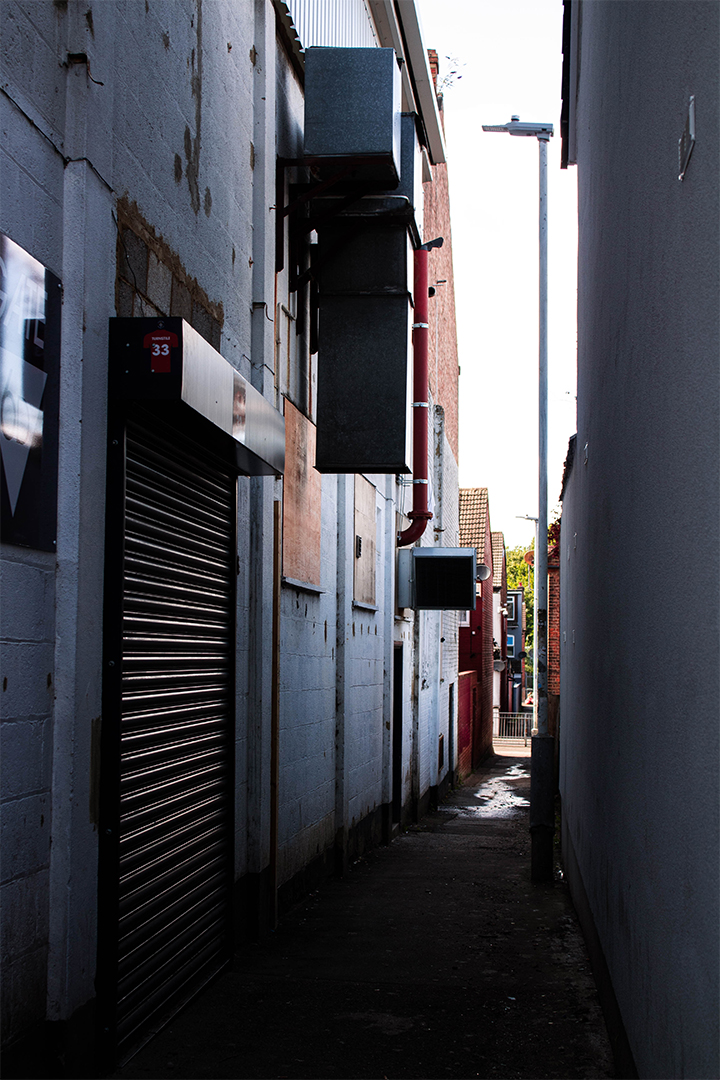 Looking down passageway inbetween the stadium and houses