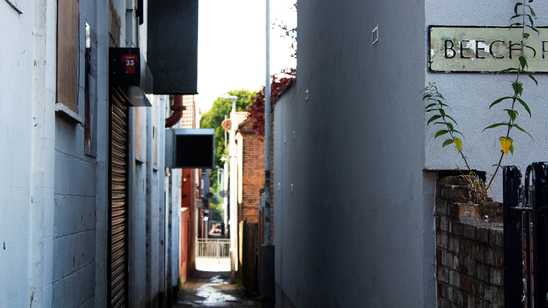 Looking down passageway inbetween the stadium and houses