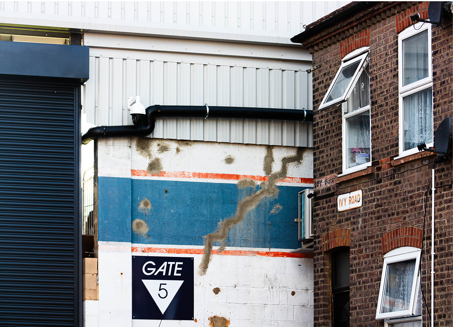 Close up of terraced house built right next to stadium gate