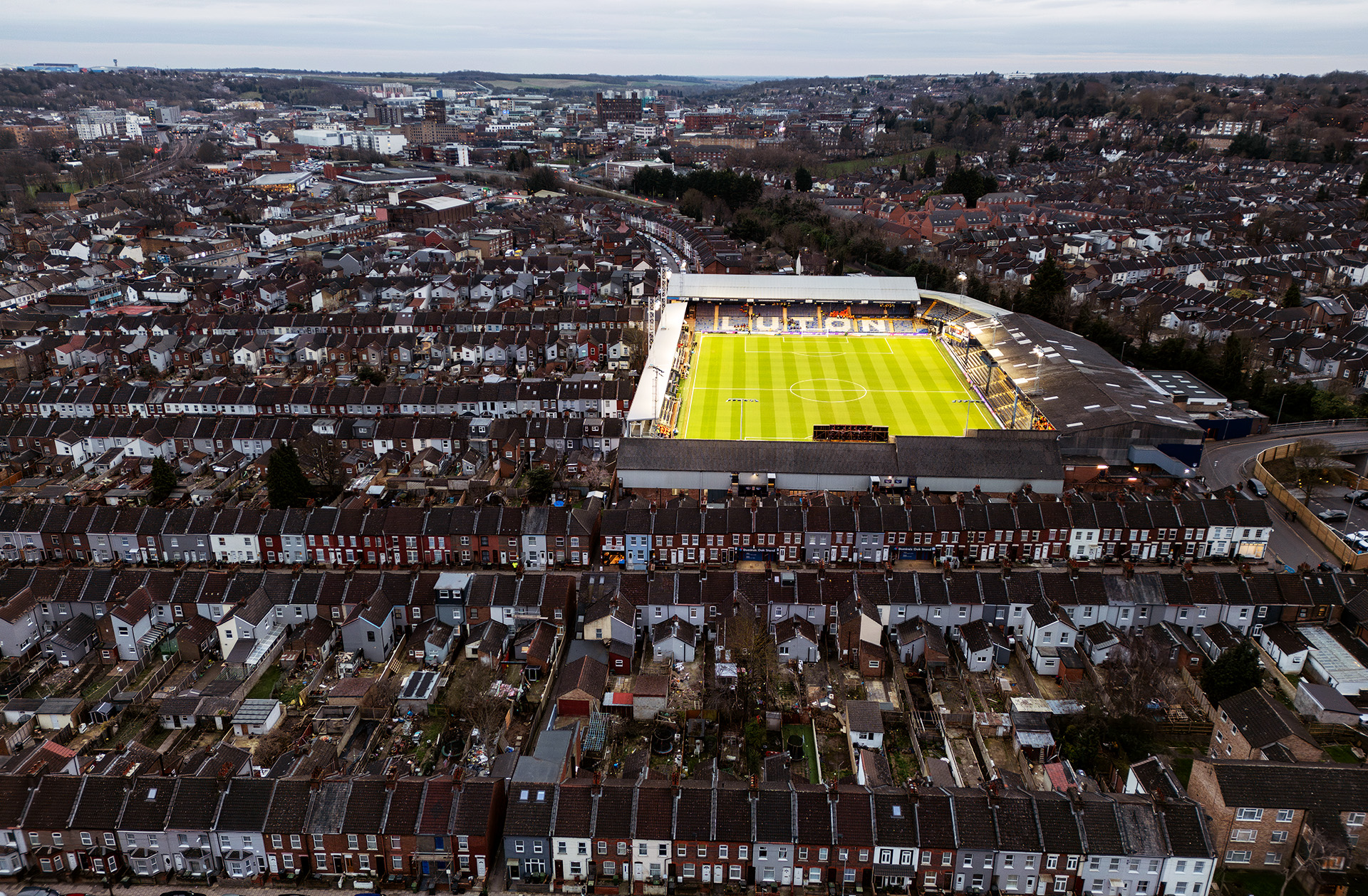 Aerial view of Luton Town stadium built amongst rows of houses