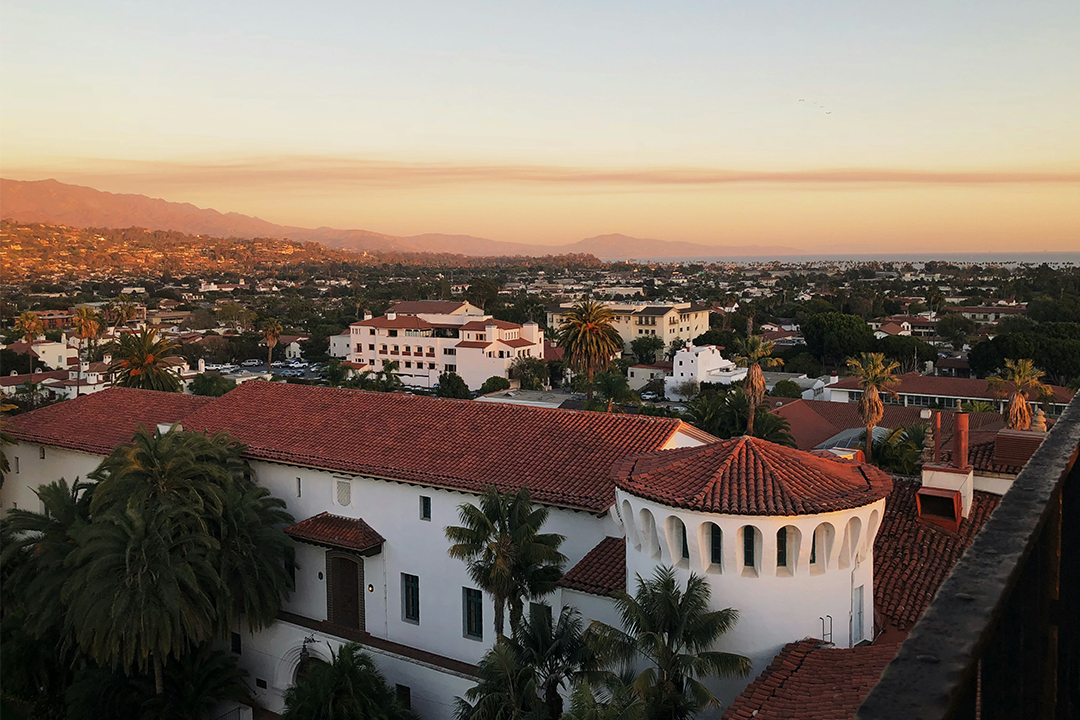Sunset over downtown Santa Barbara Overlooking red tiled roofs of white facade buildings in Spanish colonial style