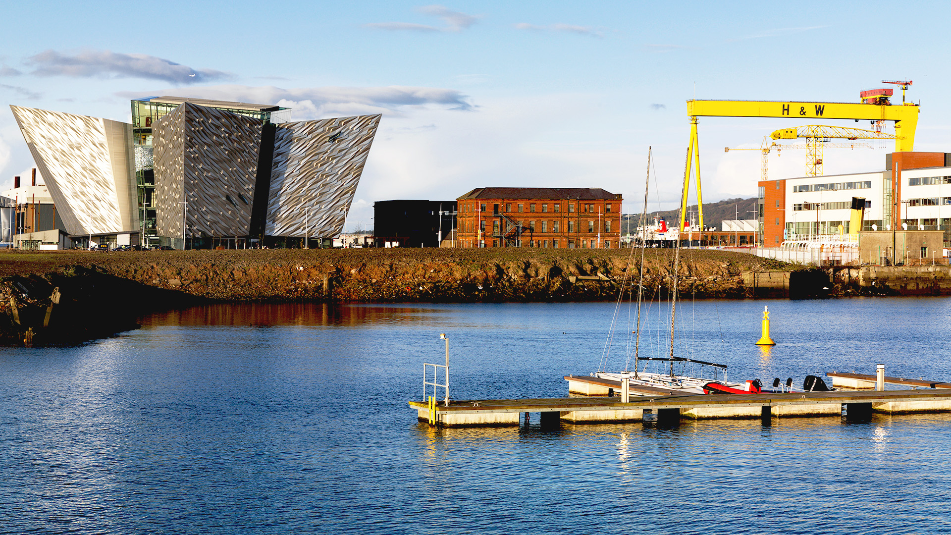 Titanic museum and yellow cranes alongside waterfront