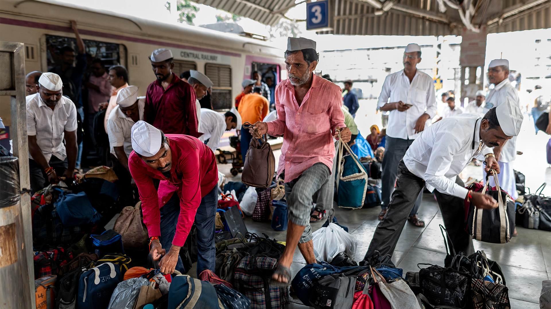 Photo of Dabbawalas carrying food onto a train
