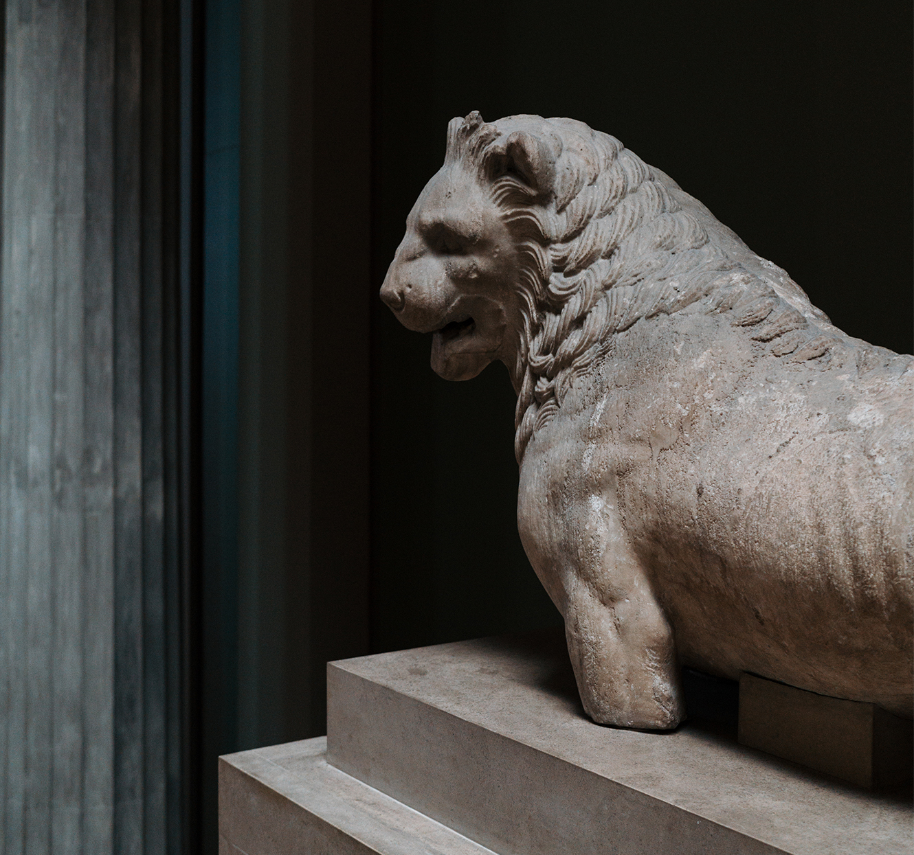 Lion sculpture on top of a plinth