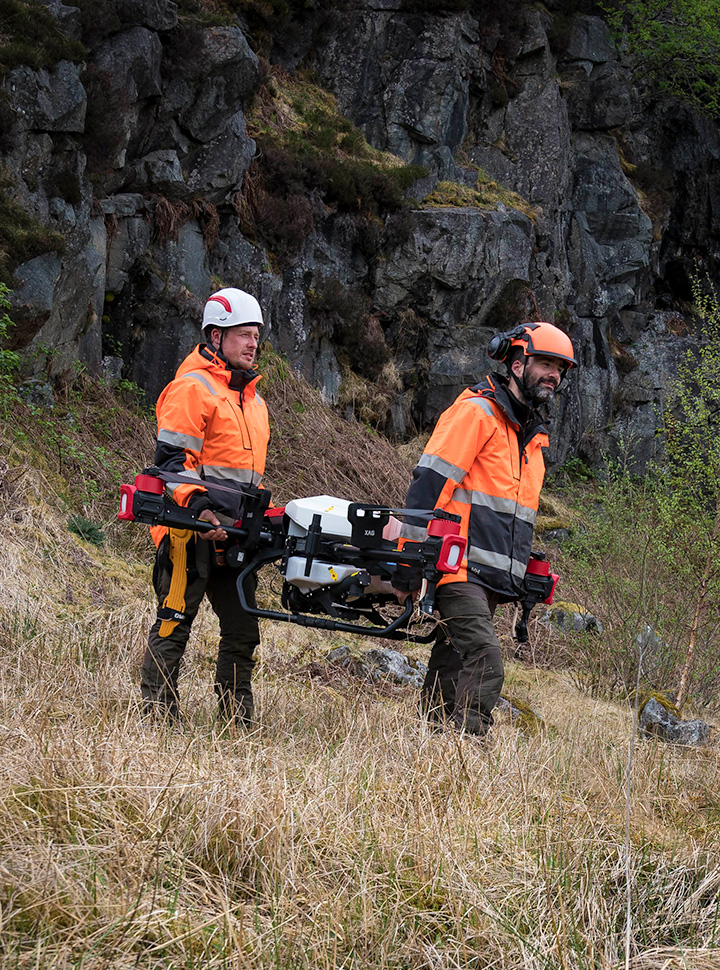 Moving equipment across terrain manually so that drones remain in visual line of sight 