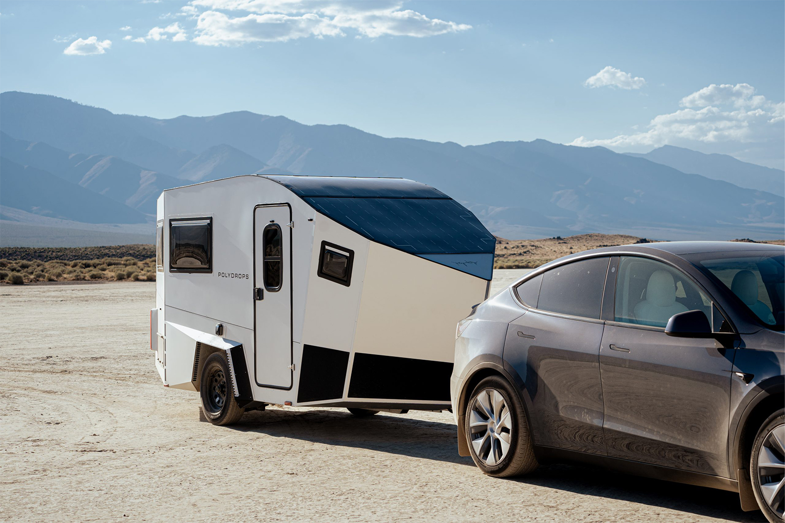 Solar powered vehicles Aptera Solar powered caravan being pulled by car mountainous backdrop