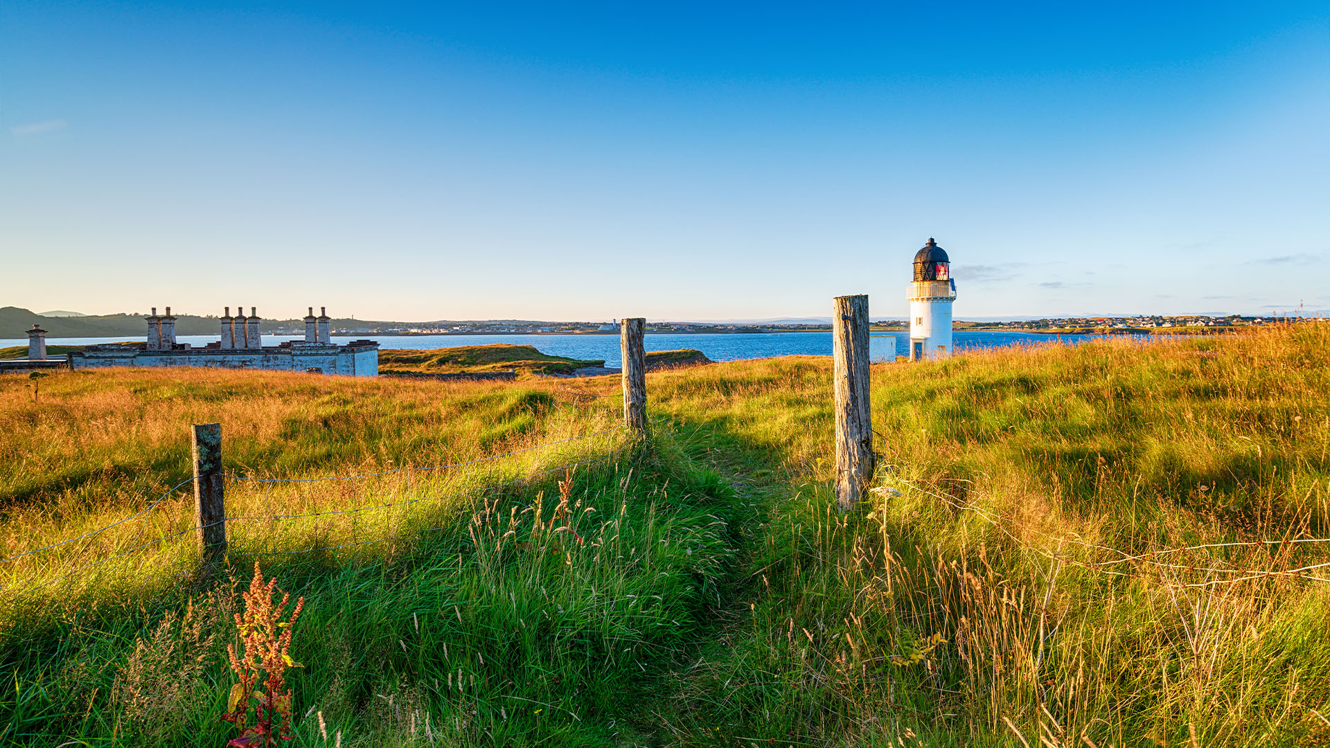 The lighthouse and coastguard cottages at Arnish Point on the entrance to Stornoway harbour on the Isle of Lewis in Scotland