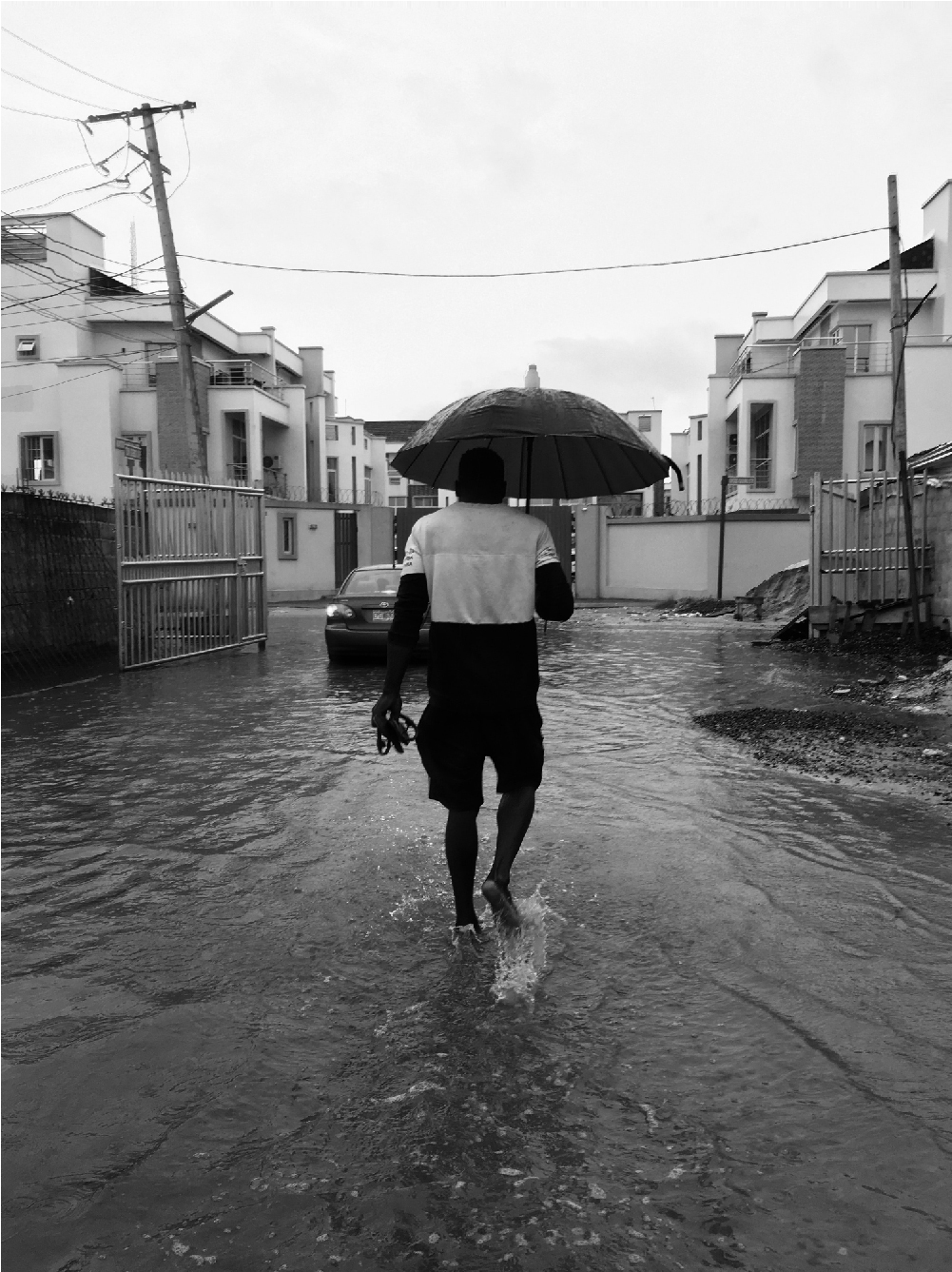 Man walking through flooded road