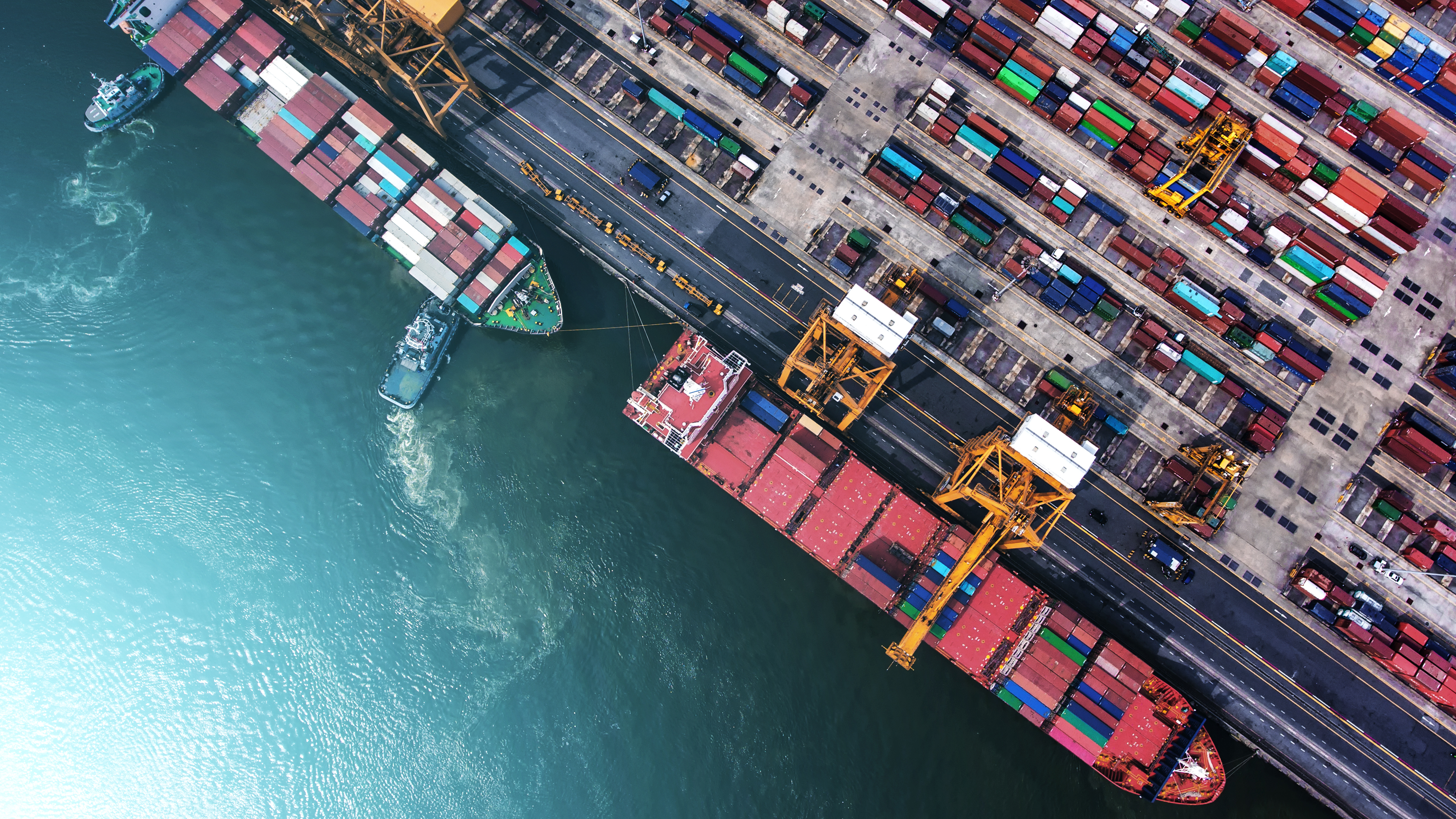 Container ship in export and import business and logistics. Shipping cargo to harbor by crane. Water transport International. Aerial view; Shutterstock ID 590511191; purchase_order: NA; job: CJ Brian Ward December 2021; client: ; other: 