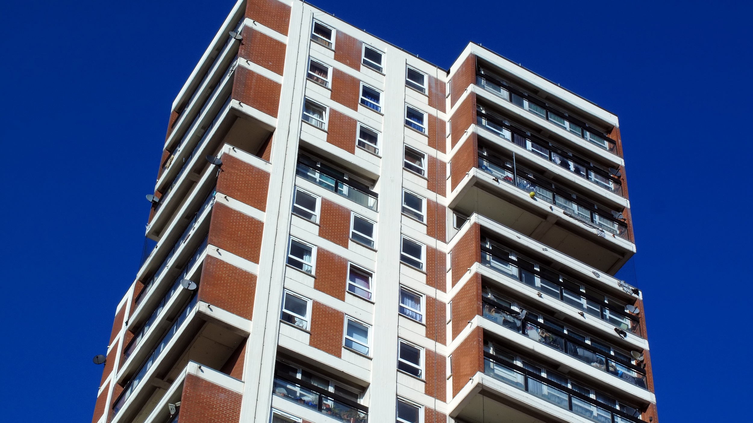 Tower block against blue sky background