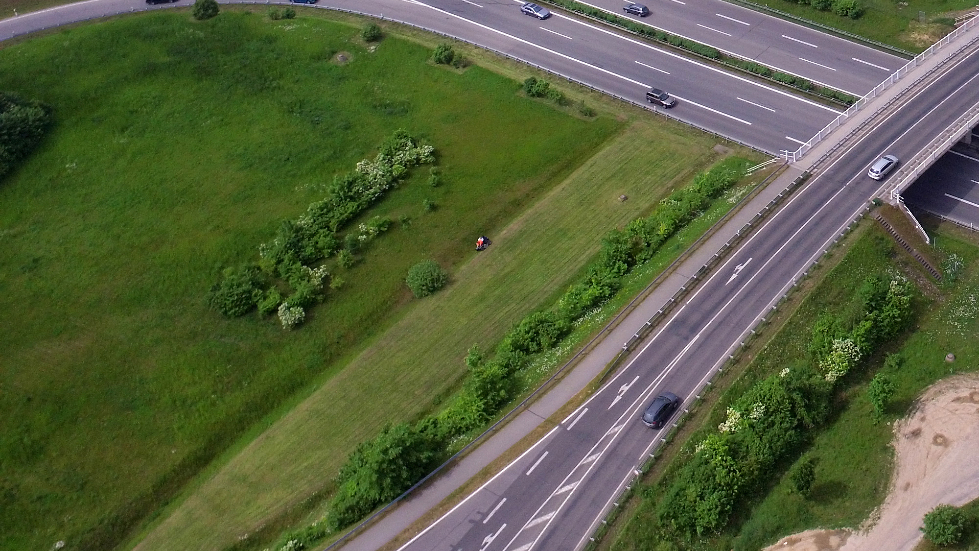 Aerial view of a highway crossing in Germany surrounded by green fields