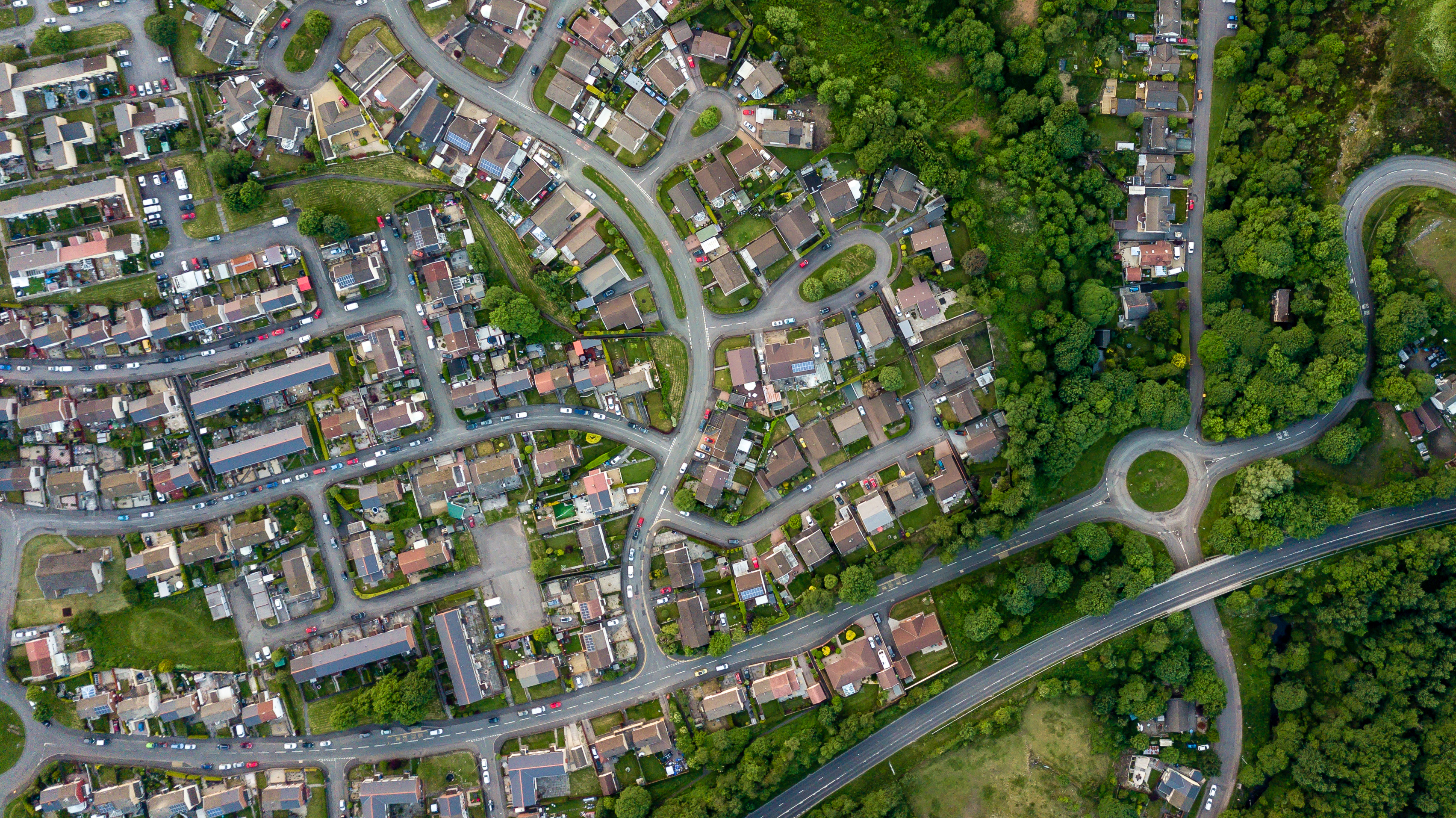 Top down aerial view of an urban area in a small town surrounded by trees and greenery; Shutterstock ID 1111441478; purchase_order: NA; job: CJ Brian Ward February 2022; client: ; other: 
