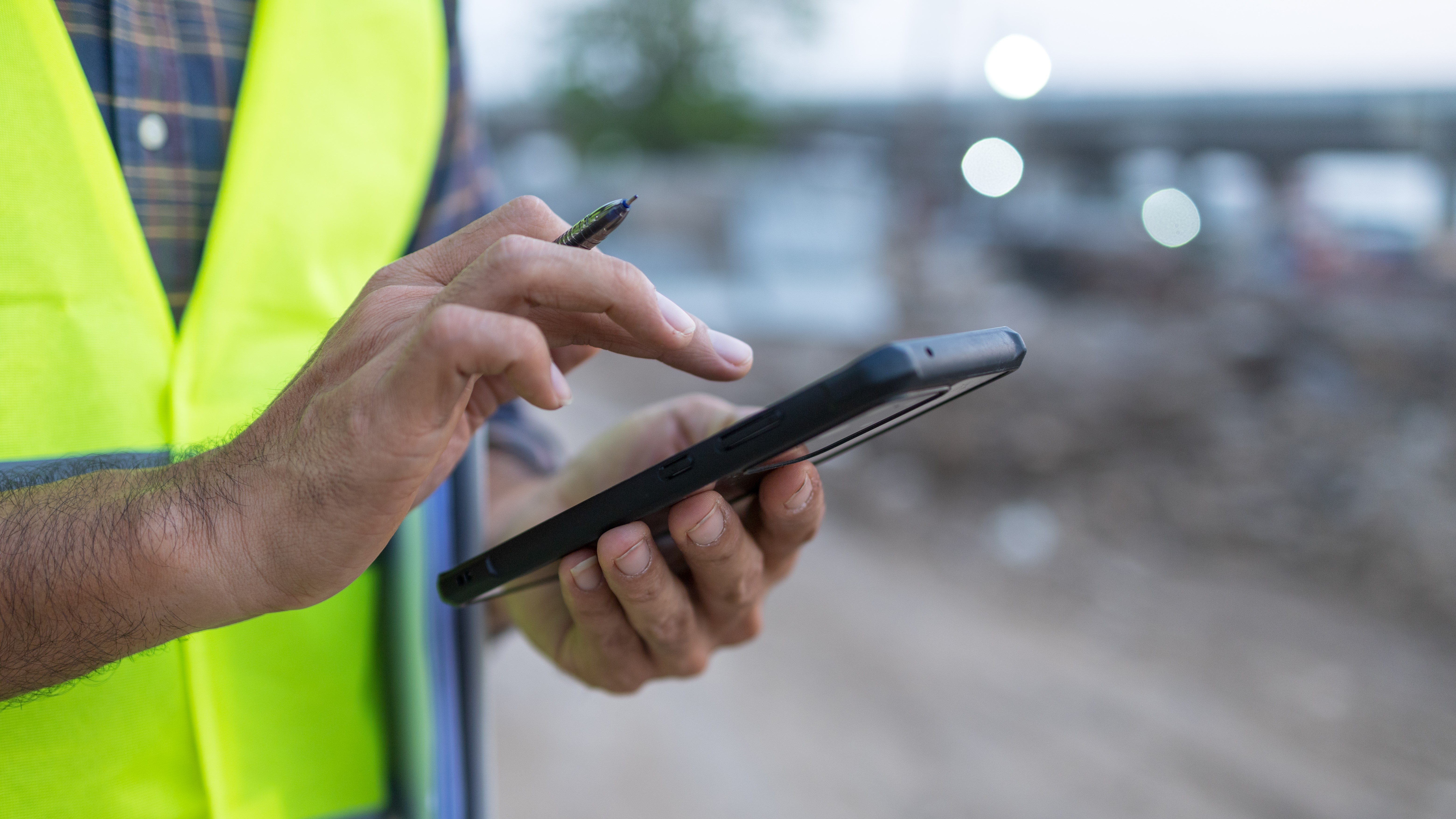 engineer working on his smartphone at the construction site; Shutterstock ID 1929227399; purchase_order: na; job: CJ GDPR SEPT; client: ; other: 