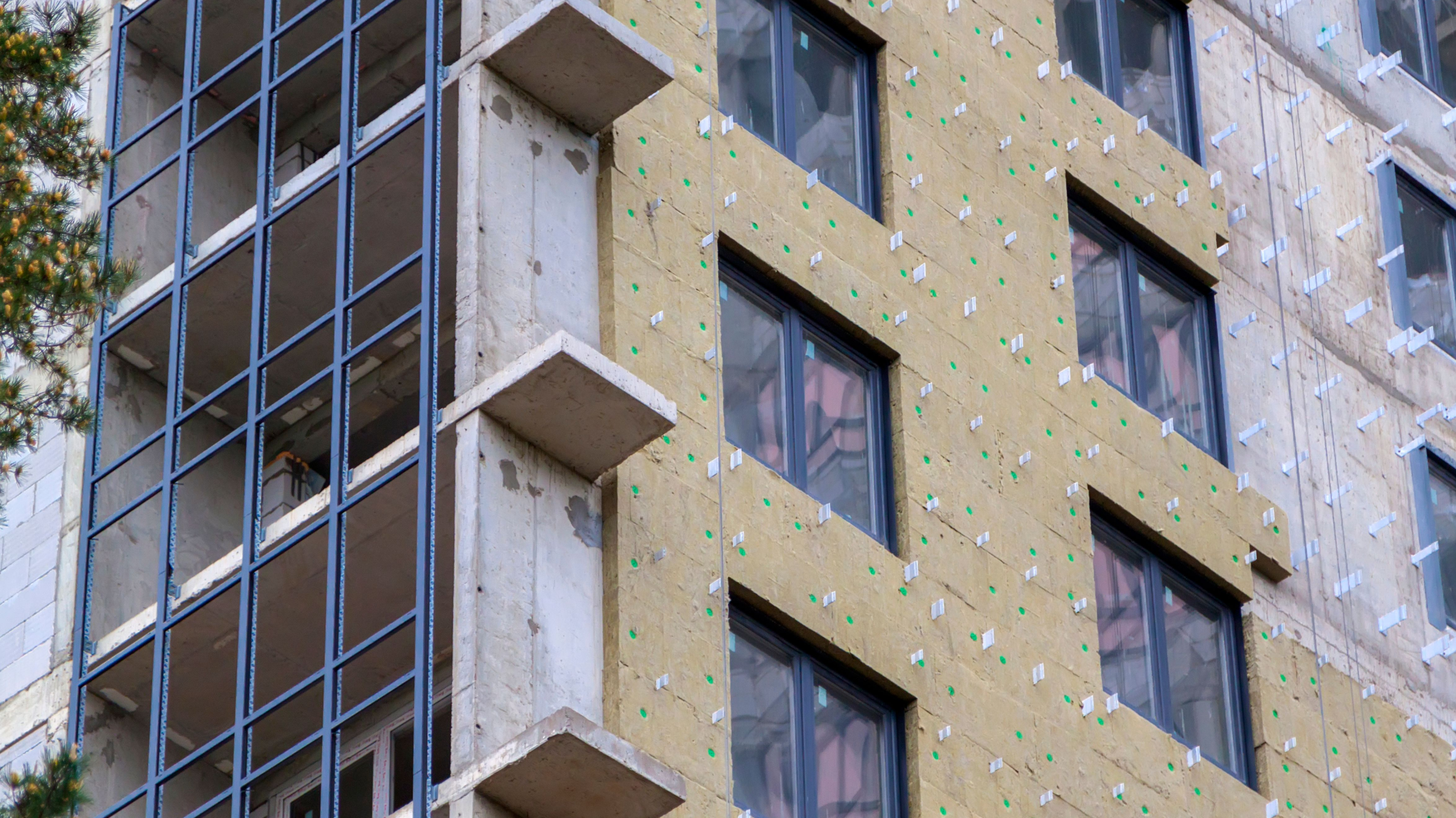 Insulation on outside of high rise in progress