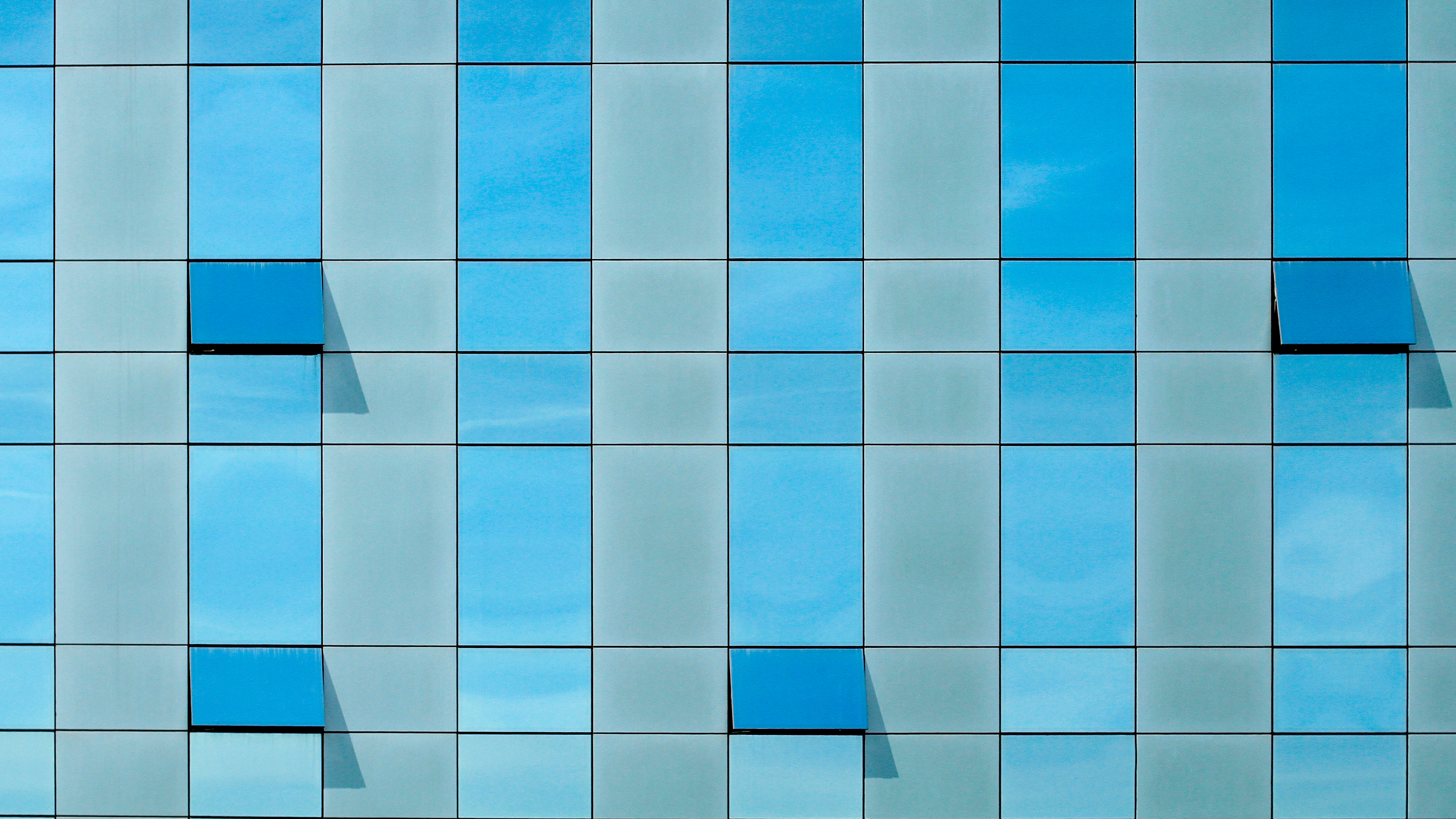 Glass-clad window building wall, with open and close windows, in daytime, without people; Shutterstock ID 1597048030; purchase_order: NA; job: RICS Property Journal Feb22; client: RICS; other: 