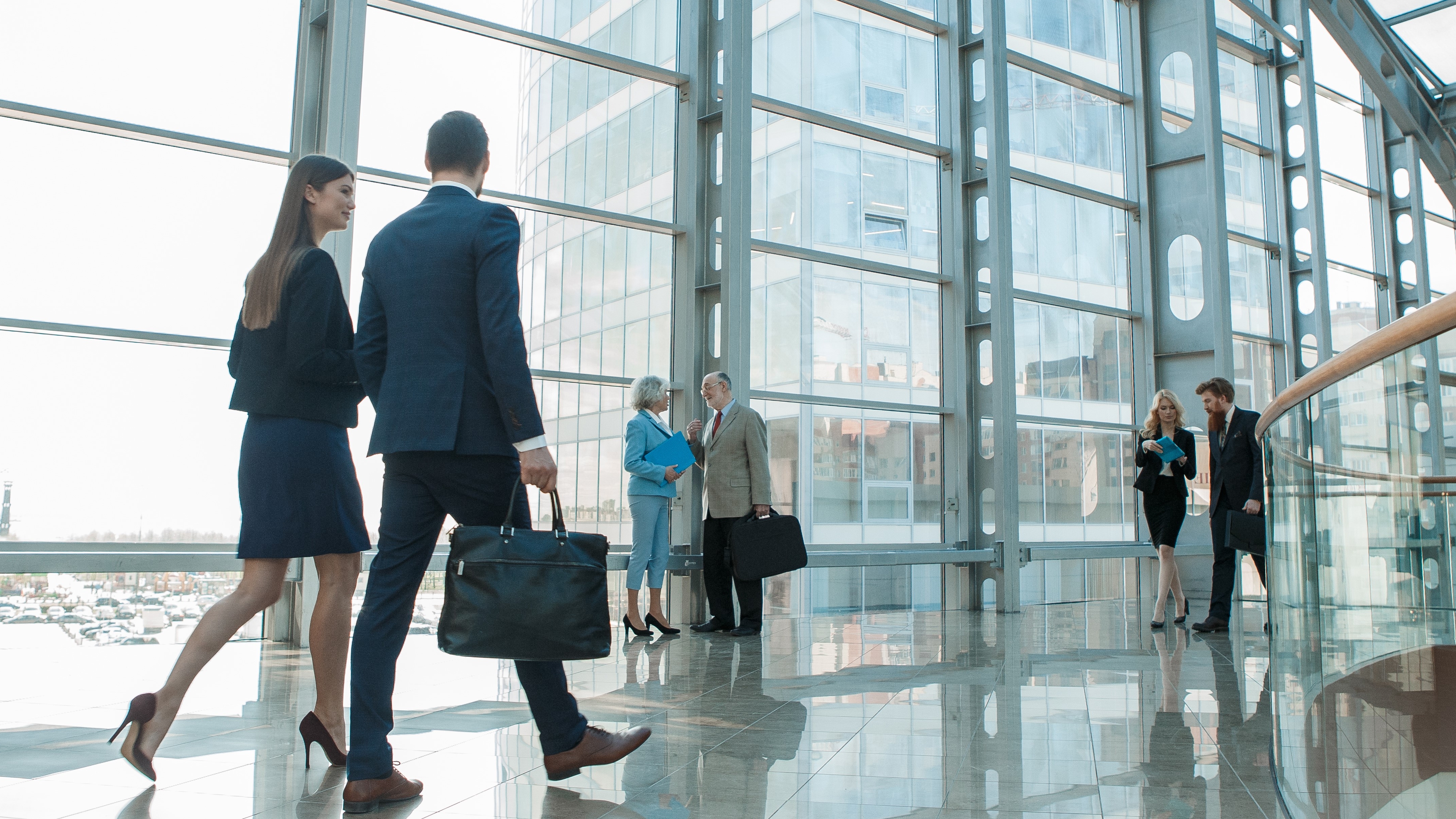 Businesspeople walking in modern glass office building