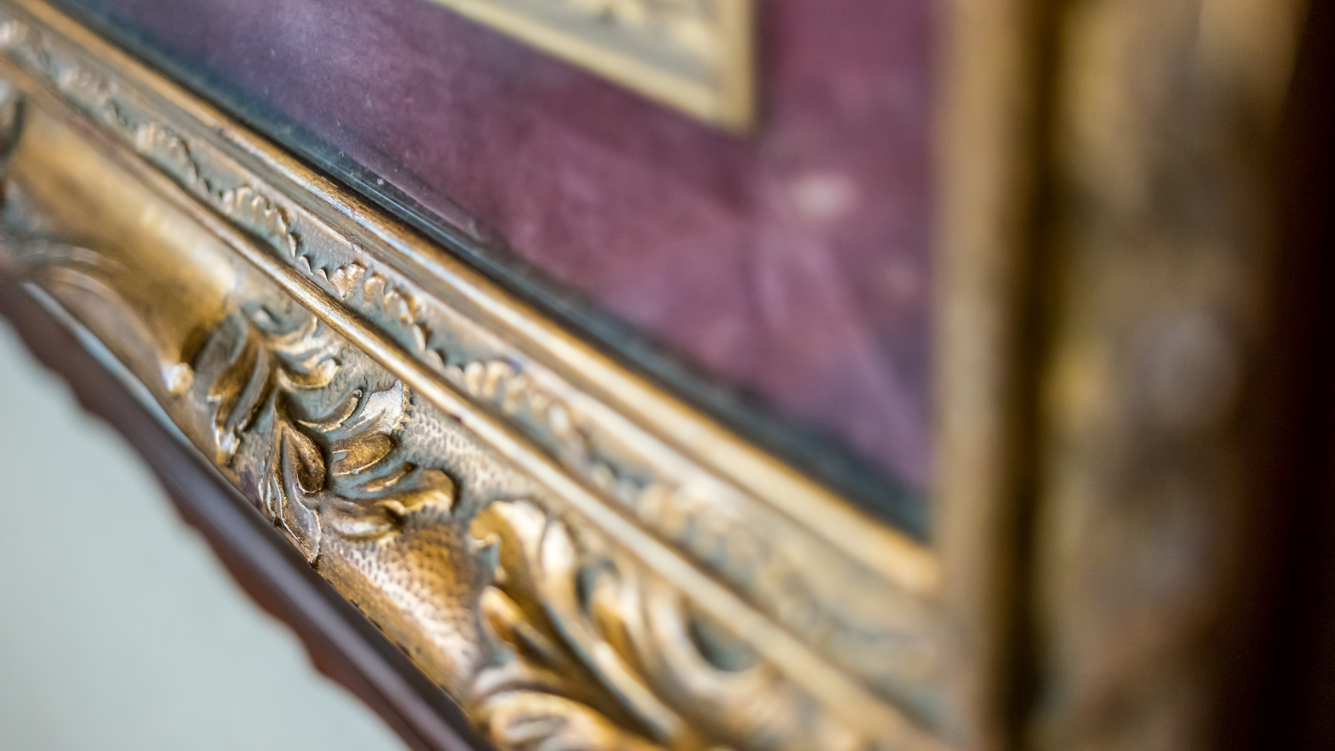 Close up of corner of old gilded frame. Antique frame with ornament.